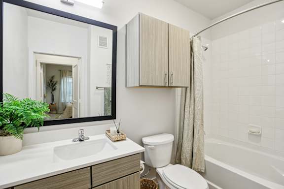 Bathroom with wood grain vanity at Matador Apartments, Austin, 78745