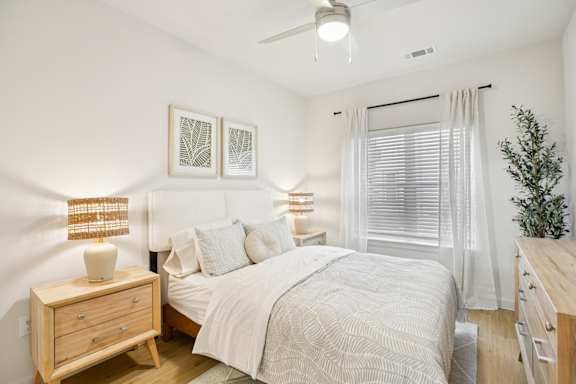 Bedroom with wood furnishings at Matador Apartments, Austin, Texas