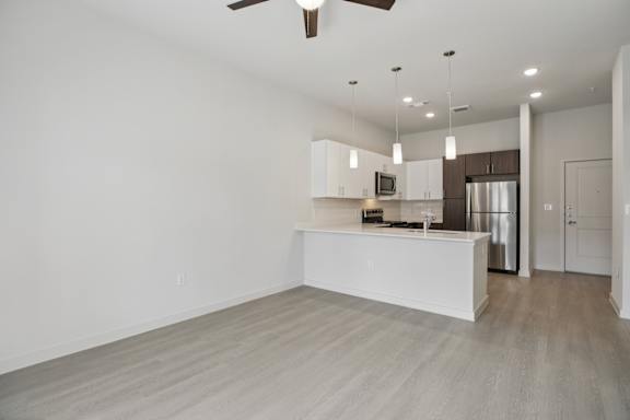 Open living and dining area with kitchen peninsula 1 at Cantarra Apartments, Texas, 78653