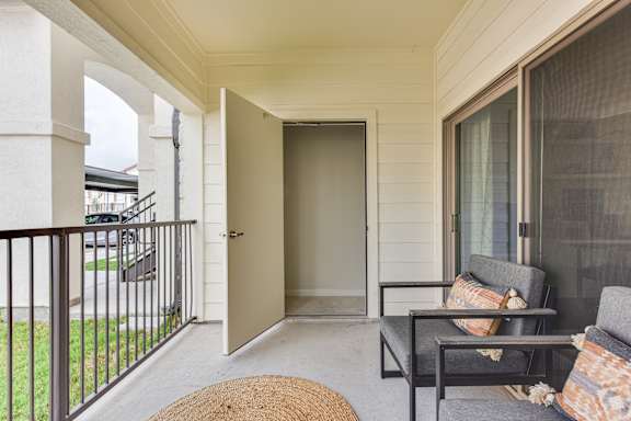 Covered patio with seating area and storage closet at High Point Preserve Apartments, Austin, Texas