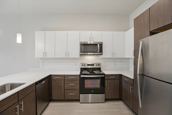 Modern kitchen with white and wood cabinetry 1 at Cantarra Apartments, Manor