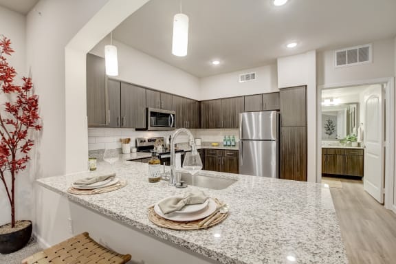 Granite Counters in kitchen at Bridge at Three Hills Apartments, Austin
