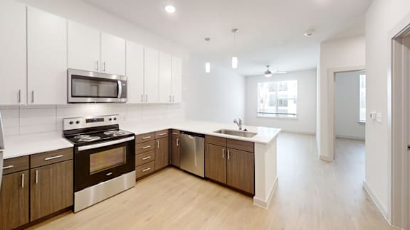 A modern kitchen with wooden cabinets and stainless steel appliances.