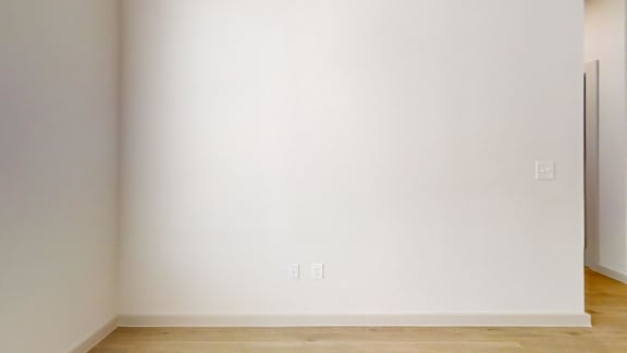 A white wall with a switch and a light socket.