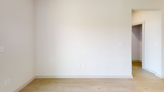 A room with white walls and wooden flooring.