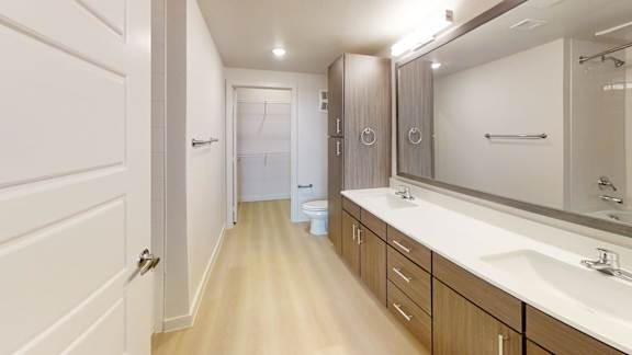 A bathroom with a white sink and a mirror.