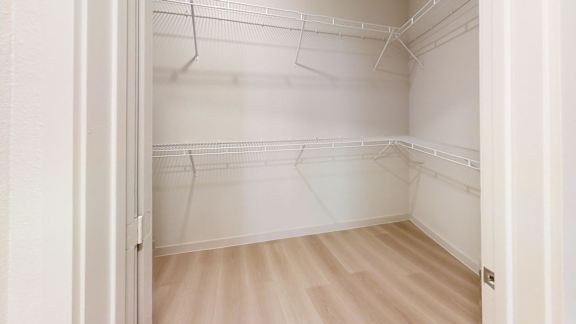 Empty white room with wooden floor and white walls.