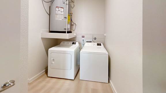 Two white toilets are sitting on a white shelf in a bathroom.