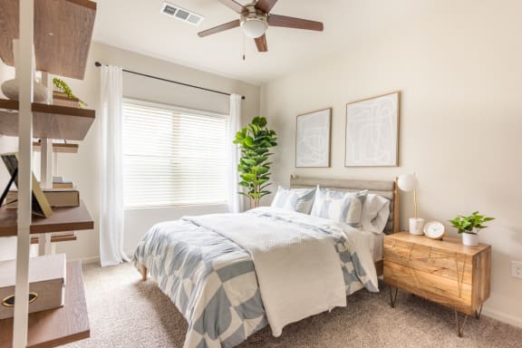 a bedroom with a large bed and a ceiling fan