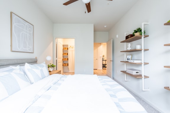 a bedroom with a bed and a ceiling fan