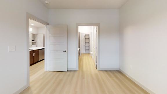 A white room with a doorway leading to another room. at Bridge at Saffron Apartments, Austin
