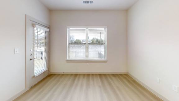 A room with a window and a door. at Bridge at Saffron Apartments, Austin, 78717