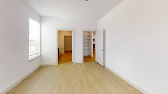 A room with a wooden floor and white walls.