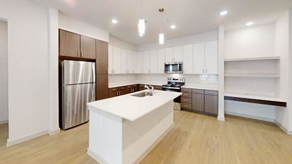 A modern kitchen with white cabinets and a wooden island.