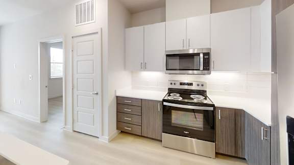 A modern kitchen with a stainless steel oven and microwave.
