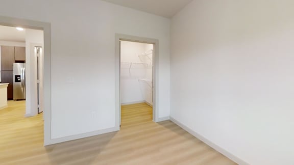 A white room with a doorway leading to another room. at Bridge at Saffron Apartments, Austin, TX
