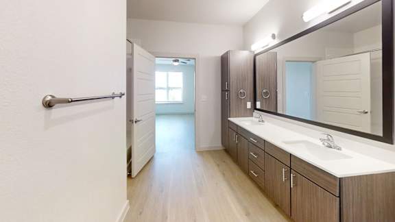 A bathroom with a white sink and a mirror.