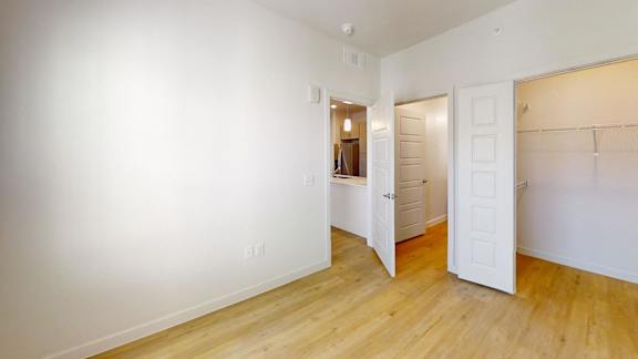 A room with a white door and a white wall.