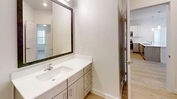 A bathroom with a sink and mirror.