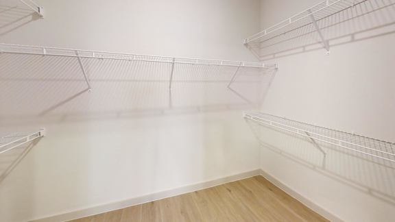 Empty room with white walls and wooden floor.