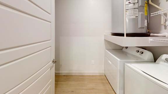 A white laundry room with a washer and dryer.