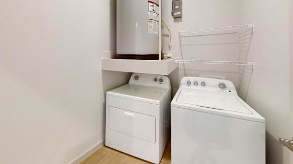 A white washing machine and dryer in a small laundry room.