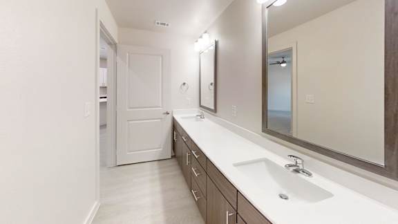 Double vanity bathroom with framed mirrors and drawers at Cantarra Apartments, Manor, 78653