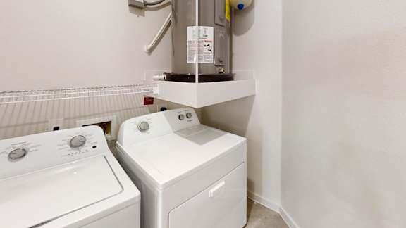 Laundry room with washer dryer and water heater 2 at Cantarra Apartments, Manor, TX 78653