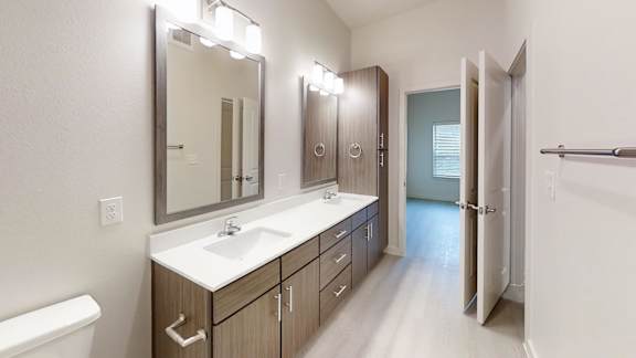 A bathroom with a white sink and a mirror above it.