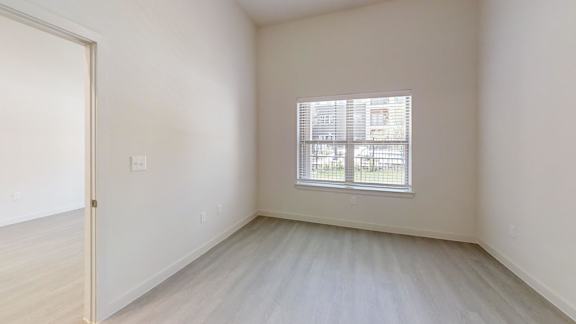 A room with a window and a door.