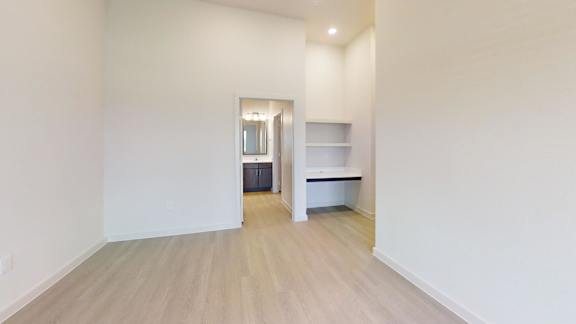 A room with a white wall and a wooden floor.