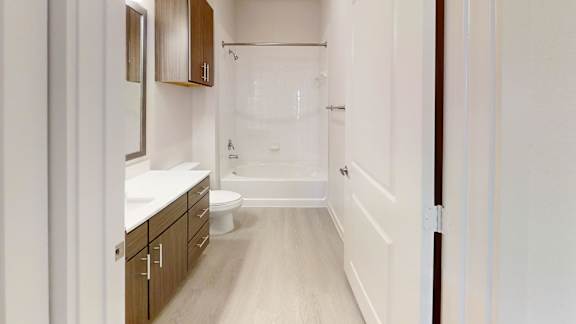 A bathroom with a walk in shower and a toilet.