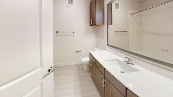 A white bathroom with a toilet and sink.