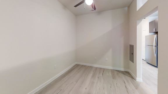 a bedroom with a medium sized bed and a kitchen in the background at Avery Ranch, Texas, 78717