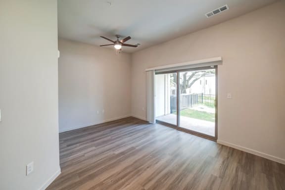 an empty living room with a sliding glass door and a ceiling fan at Avery Ranch, Austin, 78717