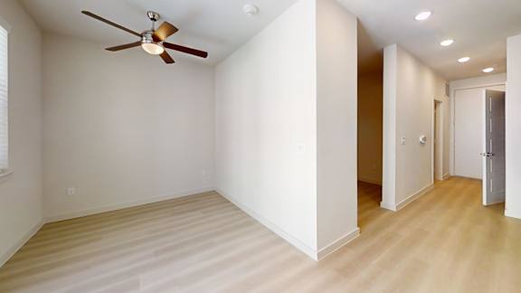 A room with a ceiling fan and lighting fixtures.