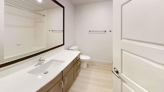 A white bathroom with a toilet in the corner at Bridge at Saffron Apartments, Texas, 78717