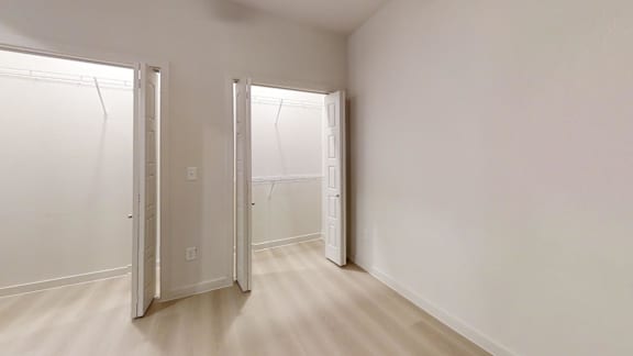 A white room with two open doors.