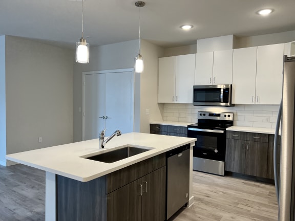 a kitchen with white cabinets and a white counter top