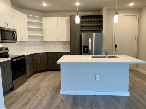 a kitchen with a center island and a stove top oven