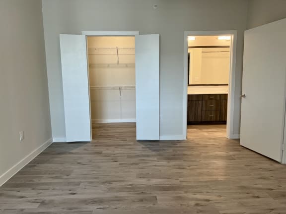 a bedroom with a medium sized closet and an open doorway