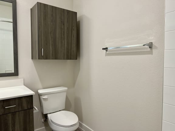 a bathroom with a toilet sink and mirror