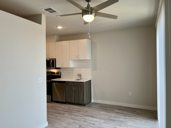 a bedroom with a ceiling fan in a room