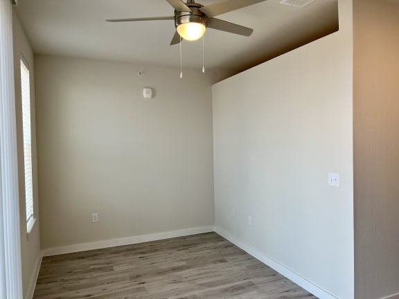 an empty room with a ceiling fan
