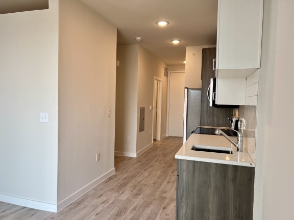 a bedroom with a medium sized bathroom and a kitchen