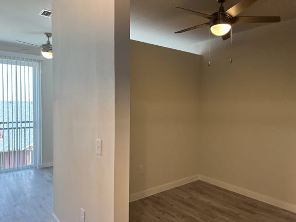 a bedroom with a ceiling fan and a window