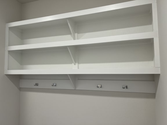 a close up of the shelving in the laundry room
