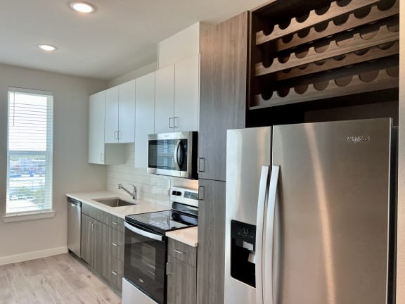 a kitchen with white cabinets and stainless steel appliances