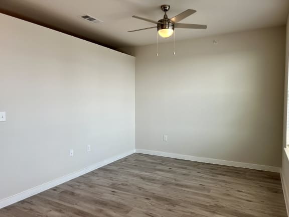 an empty room with a ceiling fan