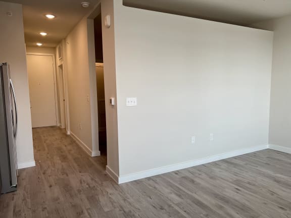 a bedroom with a medium sized bed and a refrigerator in a room